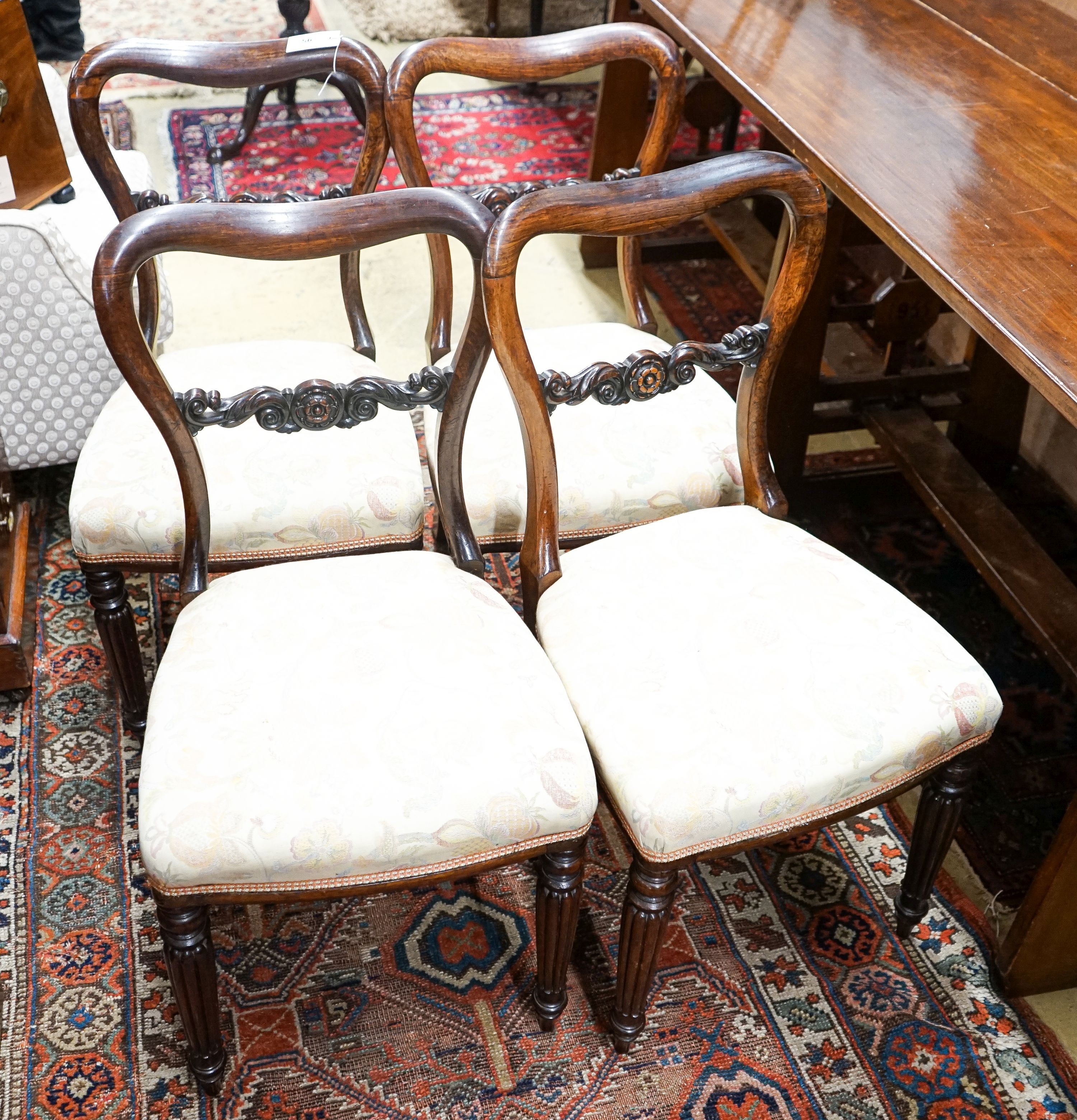 A set of four early Victorian rosewood dining chairs